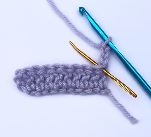 The golden needle is inserted where you should work if the turning chain doesn't count as a stitch
